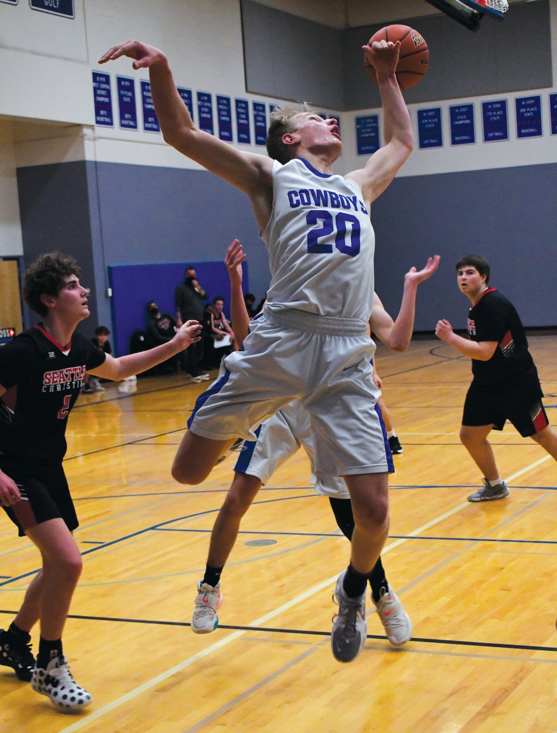 EJ senior Cade Martin scrambles for a rebound, stretching out for the ball as it glides over his head.